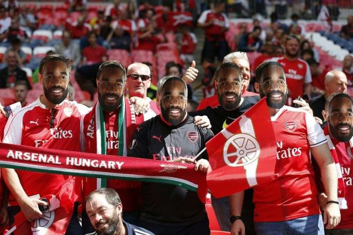 Arsenal supporters wear masks of French striker Alexandre Lacazette in the crowd ahead of the English FA Community Shield football match between Arsenal and Chelsea at Wembley Stadium in north London on August 6, 2017