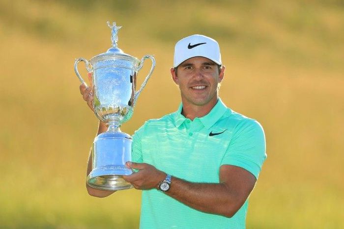 Brooks Koepka poses with the trophy after his victory at the 2017 US Open at Erin Hills on June 18, 2017