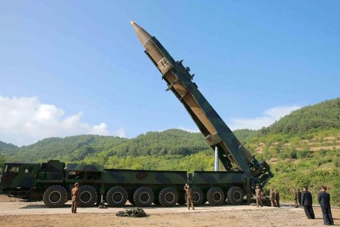 This picture taken and released on July 4, 2017 by North Korea's official Korean Central News Agency (KCNA) shows North Korean leader Kim Jong-Un (2nd R) inspecting the test-fire of the intercontinental ballistic missile Hwasong-14 at an undisclosed lo...