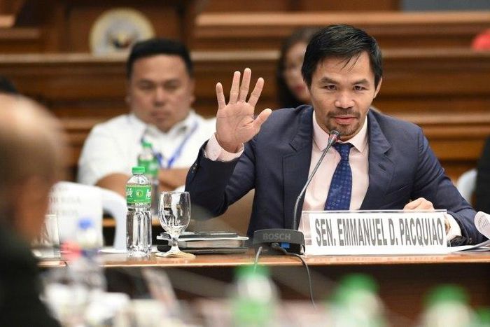 Manny Pacquiao (R) is juggling his boxing career with his role as a senator in the Philippines