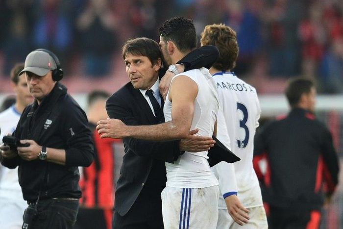 Chelsea's head coach Antonio Conte (L) embraces Chelsea's striker Diego Costa (R) at the end of the English Premier League football match between Bournemouth and Chelsea at the Vitality Stadium in Bournemouth, southern England on April 8, 2017