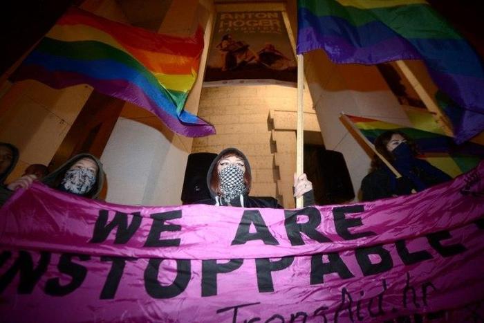 People hold up a banner during a rally in Trg Zrtava Fasizma Square in downtown Zagreb on February 13, 2017, to protest against violence against the LGBT population in Croatia