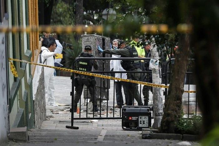 Colombian anti-explosive police inspect the site where a bomb exploded near the La Macarena bullring in downtown Bogota, Colombia, on February 19, 2017