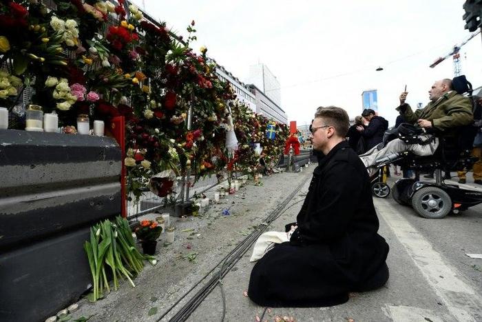 Shocked Swedes remember victims of Friday's lorry attack on a crowded Stockholm street