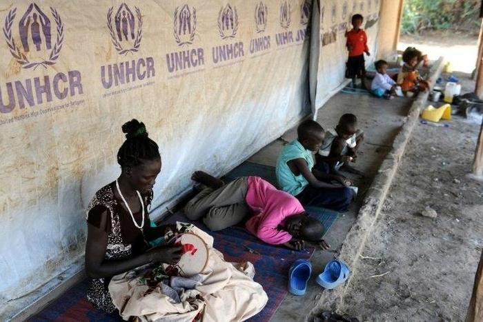 South Sudanese refugees wait outside their tent in Kakuma refugee camp, northwestern Kenya, on September 6, 2010