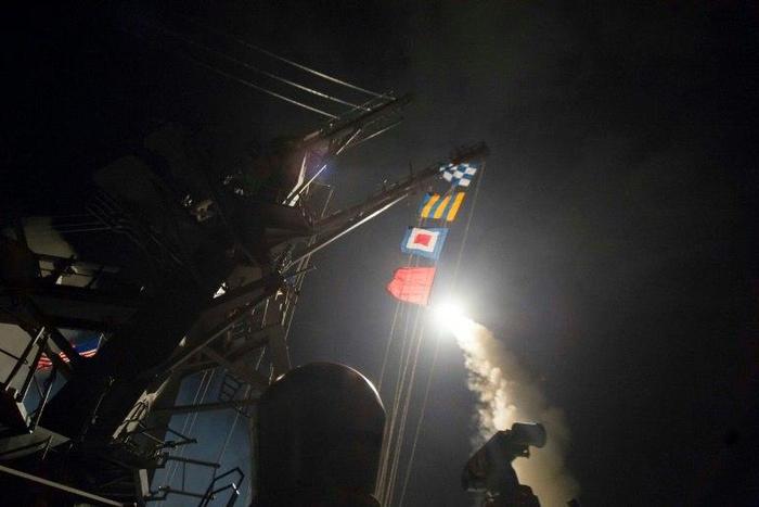 In this image released by the US Navy, the USS Ross based in the Mediterranean fires a Tomahawk land attack missile April 7, 2017, at a Syrian air force airfield