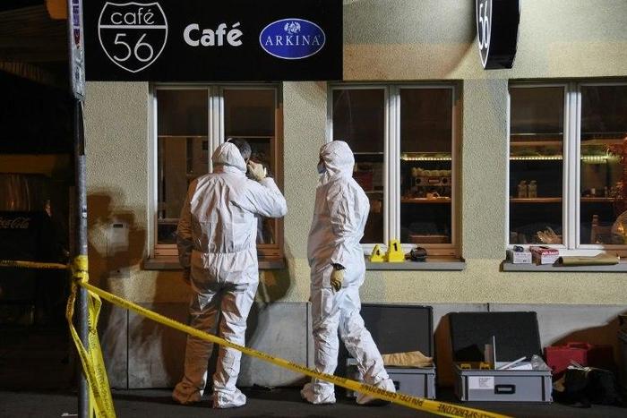 Police collect evidence at the site of a shooting on early March 10, 2017 in the city of Basel, north-west Switzerland