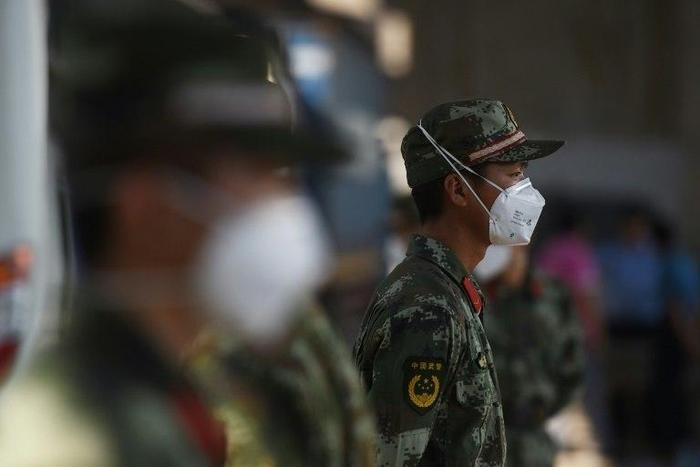 Paramilitary police wearing face masks stand guard near the site of an explosion in Tianjin, in northern China, on August 13, 2015