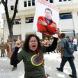 A government supporter holding a picture of late Venezuelan leader Hugo Chavez shouts slogans in favor of the new Constituent Assembly, which began work on Friday