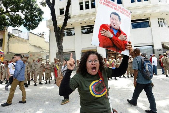 A government supporter holding a picture of late Venezuelan leader Hugo Chavez shouts slogans in favor of the new Constituent Assembly, which began work on Friday