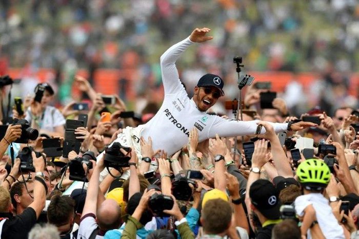 Race winner, Mercedes' British driver Lewis Hamilton, celebrates with fans after the British Formula One Grand Prix at the Silverstone motor racing circuit in central England, on July 16, 2017