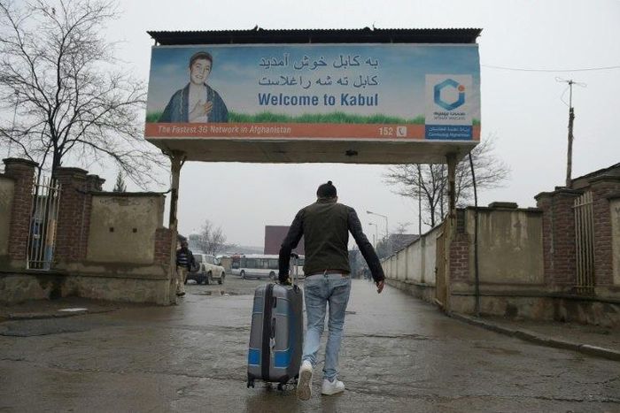 An Afghan refugee who was deported from Germany arrives with his belongings at Kabul airport on January 24, 2017