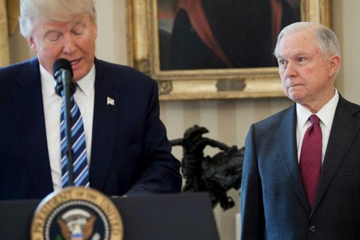 US President Donald Trump speaks alongside US Attorney General Jeff Sessions after Sessions was sworn in as Attorney General, at the Oval Office of the White House in Washington, DC, in February 2017