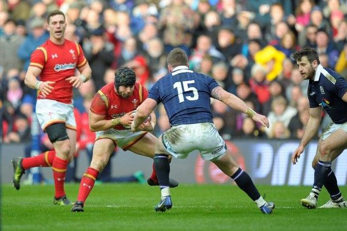 Scotland's full back Stuart Hogg (C) tackles Wales' full back Leigh Halfpenny (2L) during the Six Nations international rugby union match between Scotland and Wales at Murrayfield in Edinburgh, Scotland on Febuary 25, 2017