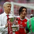 Arsenal's French manager Arsene Wenger holds the FA Cup trophy on the pitch after their win over Chelsea in the tournament final at Wembley stadium in London on May 27, 2017