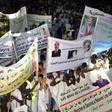 This photo taken on July 20, 2017 shows supporters of Mauritanian President gathering and holding banners during a rally ahead of the constitutional referendum on scrapping the senate and changing the national flag, in Nouakchott