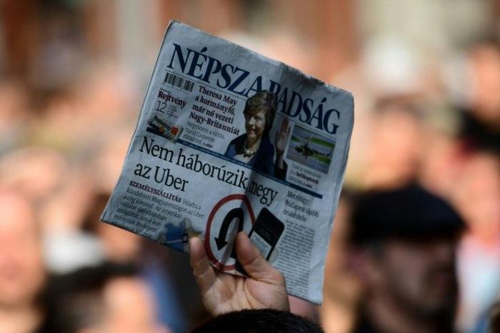A person holds a copy of Nepszabadsag daily during a protest by journalists of Hungary's biggest opposition newspaper Nepszabadsag and their supporters in Budapest on October 16, 2016