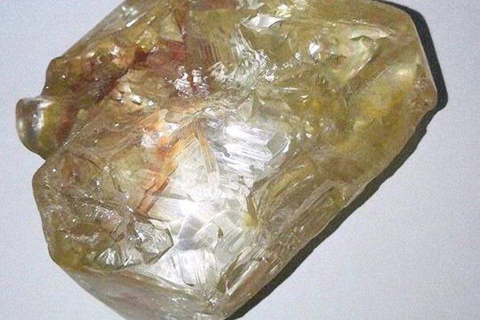 "God don bless we tiday," one of preacher Emmanuel Momoh's workers in Sierra Leone shouted brandishing a honey-coloured rock which turned out to be a 706-carat diamond