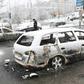 A policeman investigates a burned out car in the suburb Rinkeby, outside Stockholm, on February 21, 2017