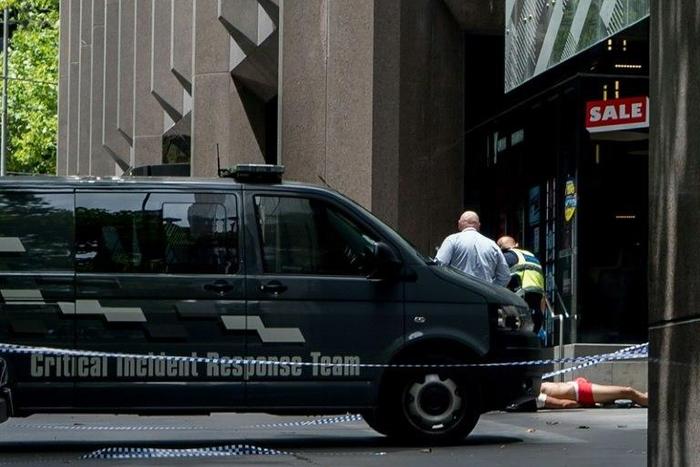 Police arrest a man (bottom-R) who allegedly drove a car into pedestrians in the centre of Melbourne on January 20, 2017