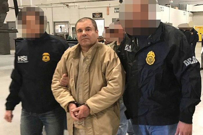 Joaquin Guzman Loera aka "El Chapo" Guzman (C) is escorted in Ciudad Juarez by the Mexican police as he is extradited to the United States
