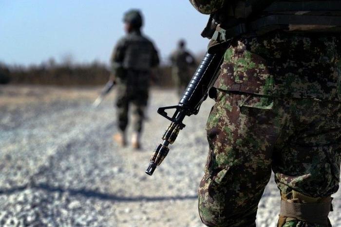 Afghan soldiers are seen on a rural road during a foot patrol