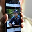 Jagan Mohan Reddy holds a smartphone with an image of his son Alok Madasani at his residence in Hyderabad on February 24, 2017, after Alok was injured in the shooting of two Indian men in the US state of Kansas