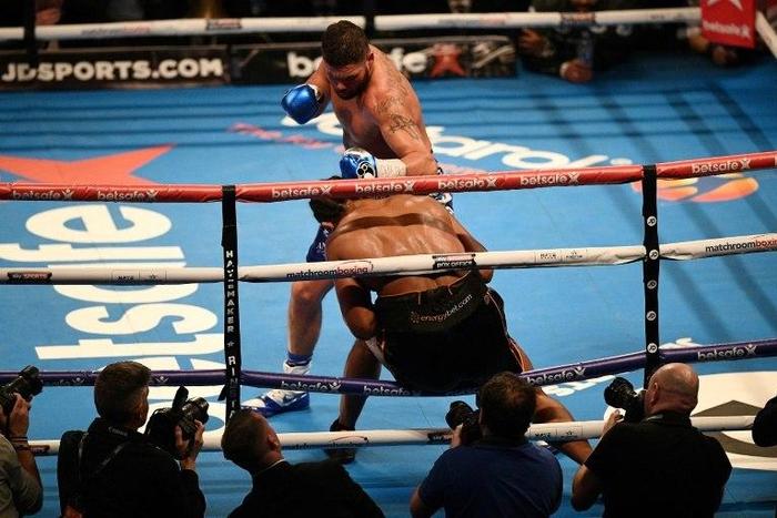 British boxer Tony Bellew (top) punches British Boxer David Haye through the ropes to win their heavyweight boxing match at the O2 arena in London on March 4, 2017