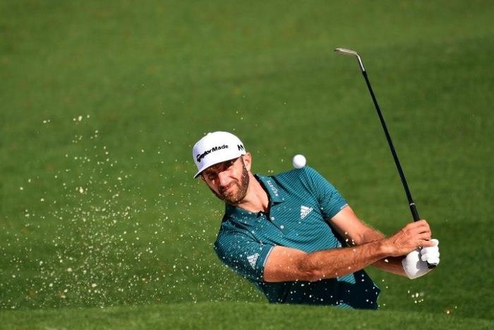 Dustin Johnson of the US plays a shot from a bunker on the second hole during a practice round prior to the start of the 2017 Masters Tournament, at Augusta National Golf Club in Georgia, on April 4