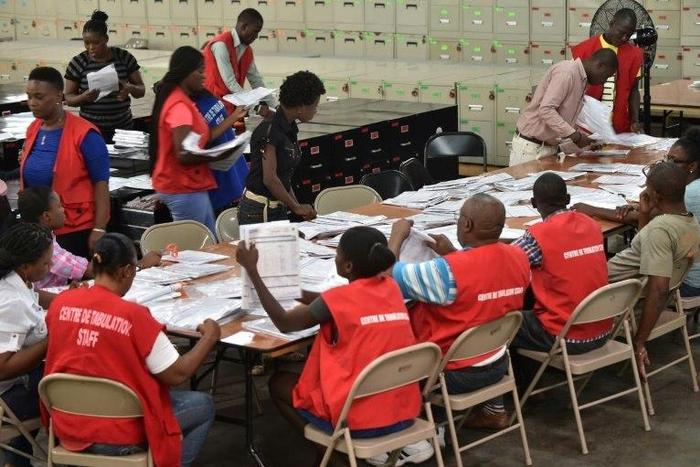 Polling center employees in Port-au-Prince tally votes on November 21, 2016