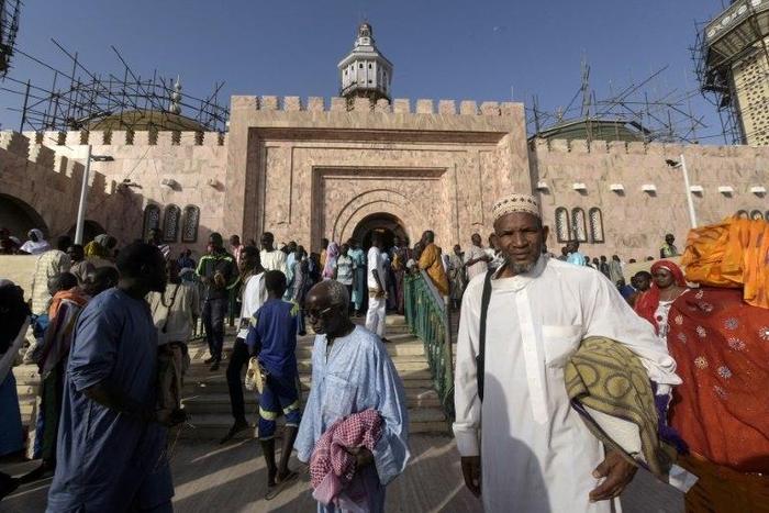 Members of the Mouride Brotherhood, a large Sufi order largely present in Senegal, queue to enter the Great Mosque in Touba on November 19, 2016