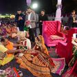 Hundreds of brides in colourful ethnic attire and ornate jewellery performed their wedding rituals in front of thousands of guests in the city of Surat