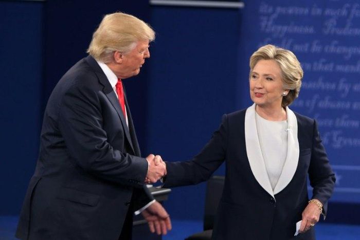 Hillary Clinton (right) and Donald Trump shake hands at the end of the second presidential debate in St. Louis, on October 9, 2016