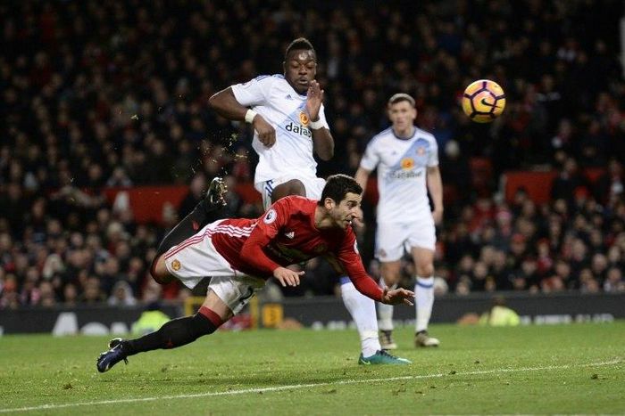 Manchester United's midfielder Henrikh Mkhitaryan (C) strikes the ball with the back of his heel to score their third goal during the English Premier League football match against Sunderland December 26, 2016