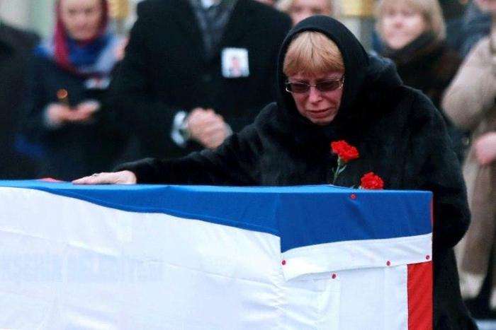 The widow of late Russian ambassador to Turkey Andrei Karlov grieves over his coffin in Ankara on December 20, 2016