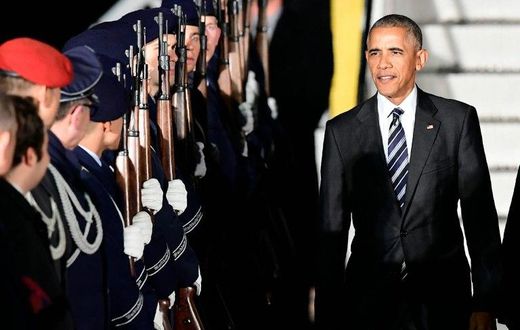 US President Barack Obama is greeted by a guard of honor after disembarking from Air Force One on November 16, 2016 at Berlin's Tegel airport