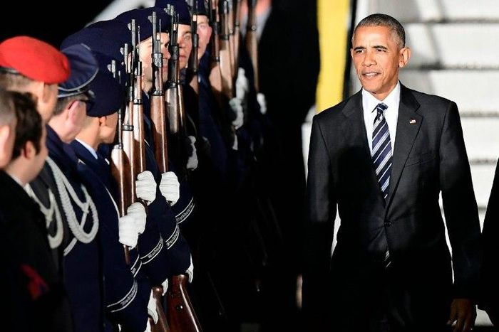 US President Barack Obama is greeted by a guard of honor after disembarking from Air Force One on November 16, 2016 at Berlin's Tegel airport