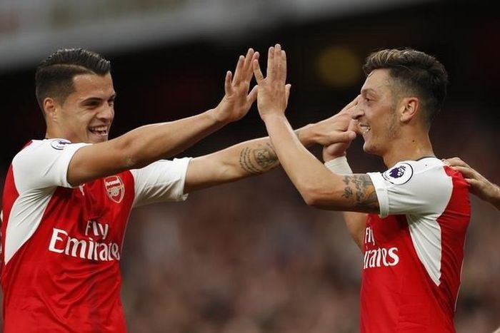 Arsenal's Mesut Ozil celebrates scoring their third goal with Granit Xhaka