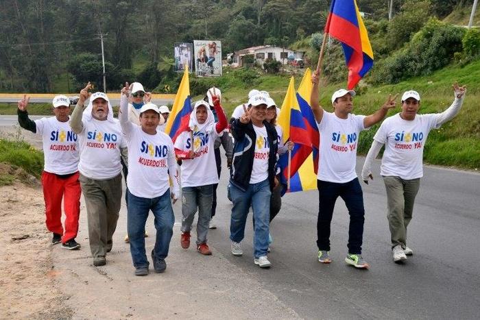 People take part in a march calling on Colombia's government and FARC rebels to reach a new peace deal