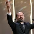 Iranian director Asghar Farhadi celebrates after being awarded the Best Screenplay prize for the film "The Salesman" at the 69th Cannes Film Festival in Cannes, southern France on May 22, 2016