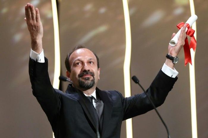Iranian director Asghar Farhadi celebrates after being awarded the Best Screenplay prize for the film "The Salesman" at the 69th Cannes Film Festival in Cannes, southern France on May 22, 2016