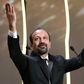 Iranian director Asghar Farhadi celebrates after being awarded the Best Screenplay prize for the film "The Salesman" at the 69th Cannes Film Festival in Cannes, southern France on May 22, 2016