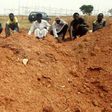 Members of the Islamic Movement of Nigeria (IMN), a Shiite group, pray at a mass grave in the outskirts of northern Nigerian city of Kaduna