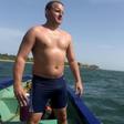 British swimmer Ben Hooper stands on a boat during a training session in Dakar on October 28, 2016