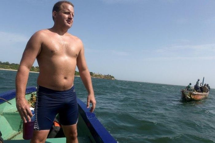 British swimmer Ben Hooper stands on a boat during a training session in Dakar on October 28, 2016