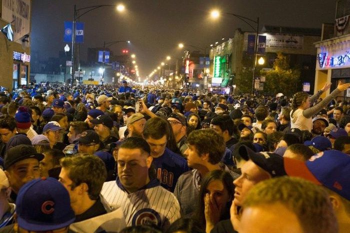 Chicago fans gather in the street to watch the Chicago Cubs take on the Cleveland Indians in Cleveland in game seven of the 2016 World Series, near Wrigley Field in Chicago, Illinois late on November 2, 2016