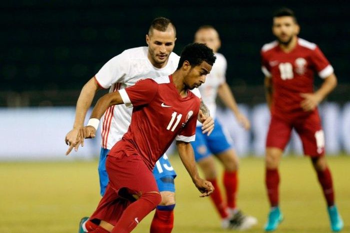 Qatar's striker Akram Afif is marked by Russia's defender Fedor Koudryashov (L) during the International friendly match between Qatar and Russia at the Jassim Bin Hamad Stadium in Doha on November 10, 2016