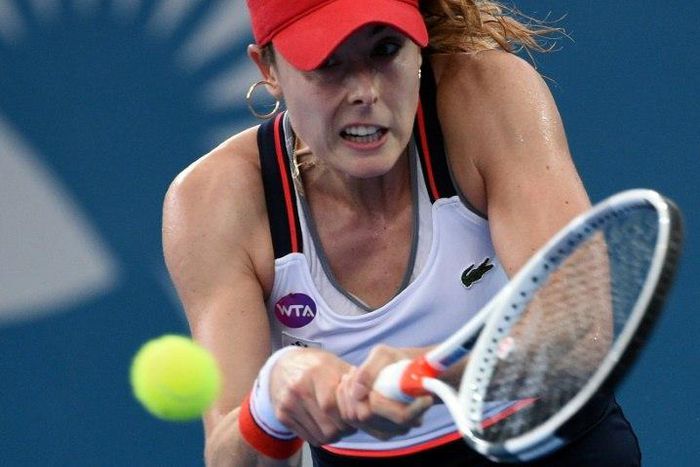 France's Alize Cornet hits a return against Garbine Muguruza of Spain in their Brisbane International semi-final on January 6, 2017