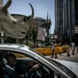 A man drives a pick-up truck carrying a mock rhino during a demonstration marking the opening of the Convention on International Trade in Endangered Species of Wild, Fauna and Flora (CITES) in Johannesburg on September 24, 2016