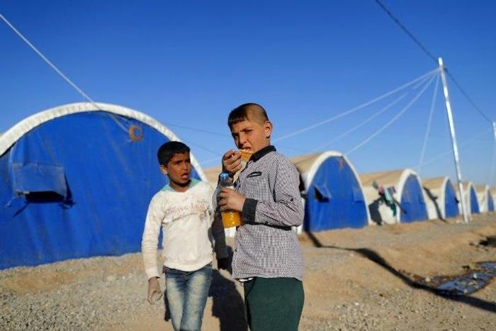 Iraqi refugees pictured at the Khazir refugee camp near the Kurdish checkpoint of Aski Kalak, 40 km west of Arbil, the capital of the autonomous Kurdish region of northern Iraq, on November 21, 2016